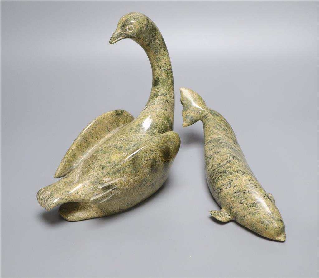 A carved Inuit whale and a similar carved swan